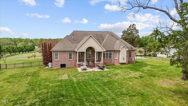 2011 Gibsonville Ossipee Rd, Elon, NC 27244 - rear view of house with a patio area, brick siding, a fenced backyard, and an outdoor fire pit