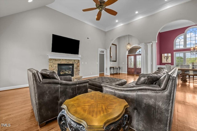 2011 Gibsonville Ossipee Rd, Elon, NC 27244 - living room featuring arched walkways, decorative columns, a chandelier, high vaulted ceiling, and a ceiling fan