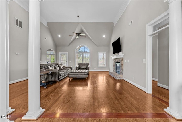 2011 Gibsonville Ossipee Rd, Elon, NC 27244 - living room with ornate columns, ceiling fan, wood finished floors, a stone fireplace, and high vaulted ceiling