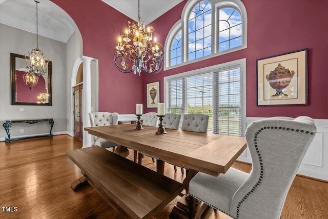2011 Gibsonville Ossipee Rd, Elon, NC 27244 - dining space featuring a chandelier, wood finished floors, healthy amount of natural light, arched walkways, and a high ceiling