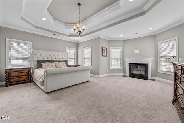 2011 Gibsonville Ossipee Rd, Elon, NC 27244 - bedroom with ornamental molding, carpet flooring, multiple windows, a raised ceiling, and a fireplace with flush hearth