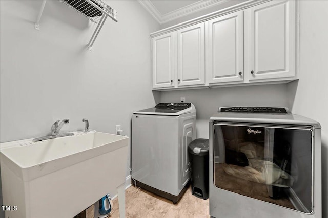 2011 Gibsonville Ossipee Rd, Elon, NC 27244 - laundry room featuring washing machine and dryer, cabinet space, and ornamental molding