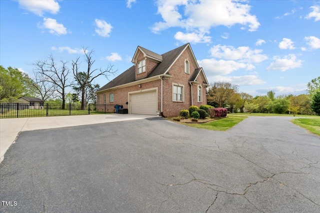 2011 Gibsonville Ossipee Rd, Elon, NC 27244 - view of property exterior with brick siding, a garage, and driveway