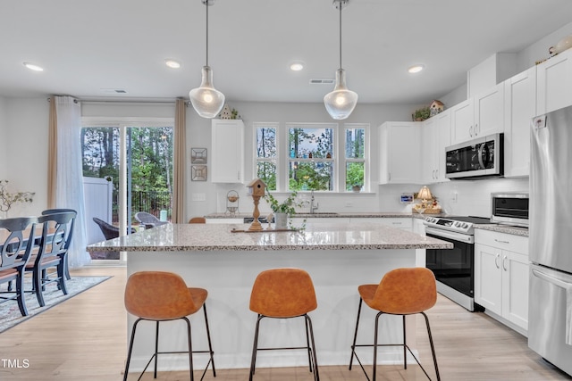 110 Gilder Woods Dr, Garner, NC 27529 - kitchen featuring a kitchen breakfast bar, plenty of natural light, appliances with stainless steel finishes, a center island, and recessed lighting