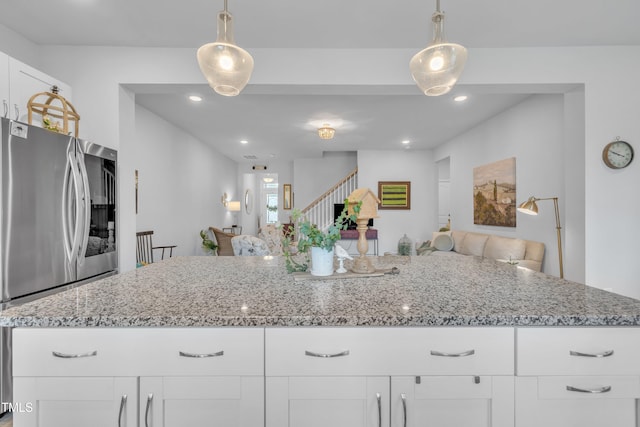 110 Gilder Woods Dr, Garner, NC 27529 - kitchen featuring smart refrigerator, open floor plan, light stone counters, white cabinets, and decorative light fixtures