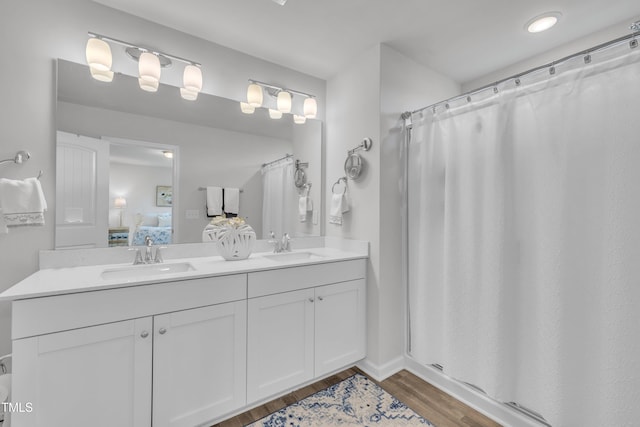 110 Gilder Woods Dr, Garner, NC 27529 - ensuite bathroom featuring double vanity, wood finished floors, and a shower with curtain