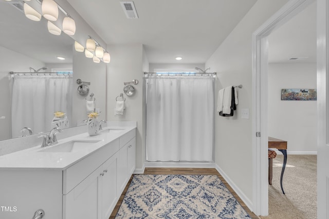 110 Gilder Woods Dr, Garner, NC 27529 - full bathroom with a shower with shower curtain, double vanity, and recessed lighting