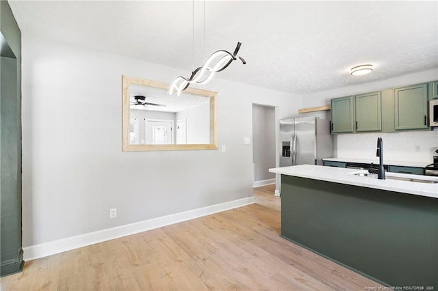 6123 Malvern Cir, Fayetteville, NC 28314 - kitchen with green cabinets, stainless steel fridge, light countertops, and white microwave