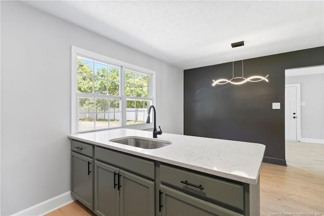 6123 Malvern Cir, Fayetteville, NC 28314 - kitchen featuring gray cabinets, light wood finished floors, and hanging light fixtures