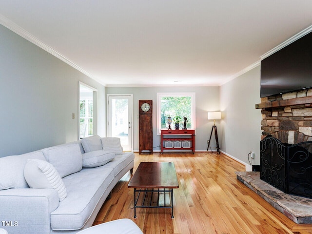 3525 Lytham Pl, Raleigh, NC 27604 - living area featuring light wood-style floors, crown molding, and a stone fireplace