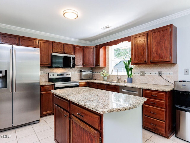 3525 Lytham Pl, Raleigh, NC 27604 - kitchen featuring appliances with stainless steel finishes, light tile patterned flooring, crown molding, backsplash, and a center island