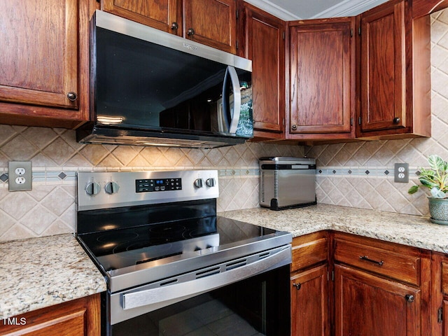 3525 Lytham Pl, Raleigh, NC 27604 - kitchen featuring stainless steel appliances, backsplash, tile patterned floors, and light stone countertops