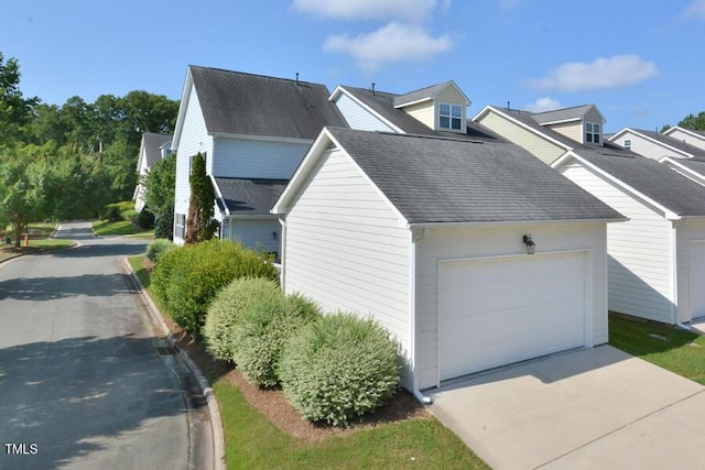 1079 Perdue Dr, Chapel Hill, NC 27517 - view of property exterior with concrete driveway, a garage, and a shingled roof