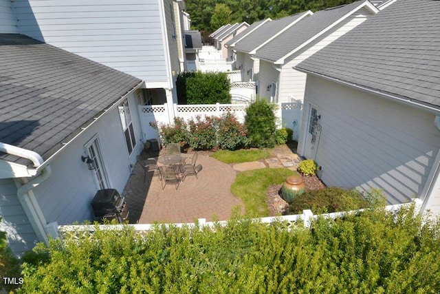 1079 Perdue Dr, Chapel Hill, NC 27517 - view of side of home with a fenced backyard, a patio area, and a shingled roof