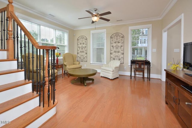 1079 Perdue Dr, Chapel Hill, NC 27517 - living area featuring light wood finished floors, a ceiling fan, ornamental molding, and stairs