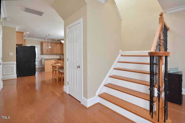 1079 Perdue Dr, Chapel Hill, NC 27517 - stairway featuring wood finished floors and ornamental molding