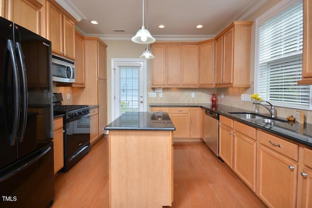 1079 Perdue Dr, Chapel Hill, NC 27517 - kitchen featuring black appliances, a kitchen island, light wood-type flooring, tasteful backsplash, and crown molding