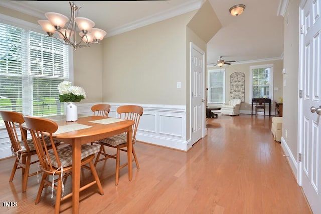 1079 Perdue Dr, Chapel Hill, NC 27517 - dining room with a chandelier, ornamental molding, wainscoting, light wood-style flooring, and a ceiling fan