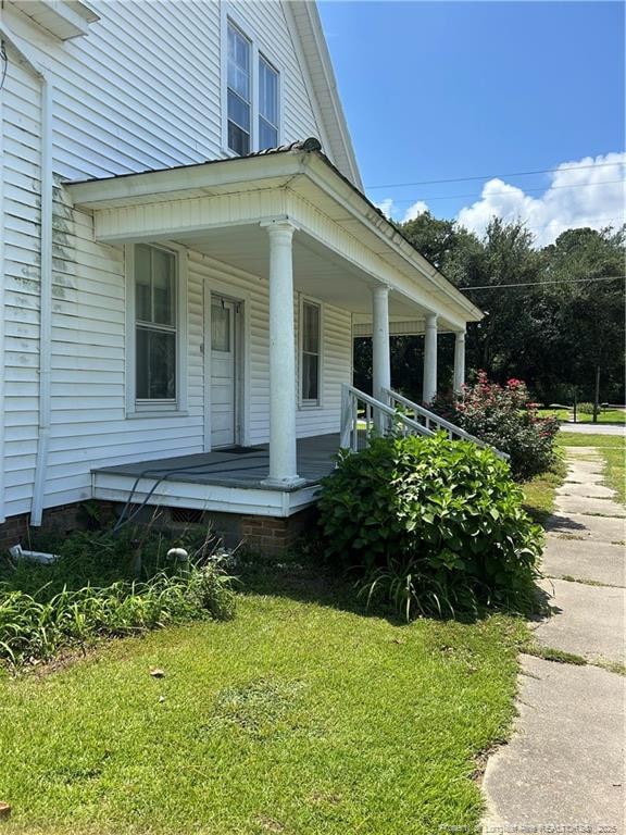 512 W Main St W, Rowland, NC 28383 - doorway to property featuring a porch and a yard