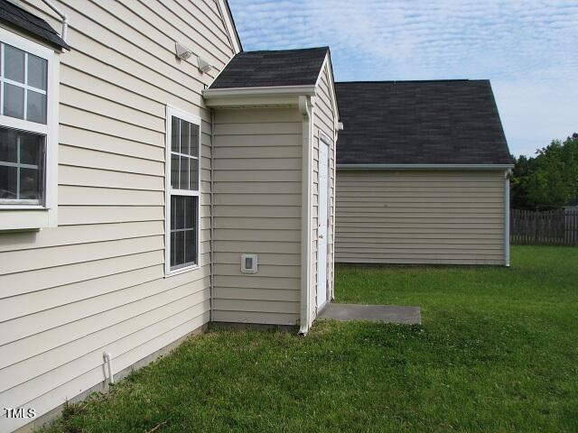 4419 Nightfall Ct, Durham, NC 27713 - view of side of property with a lawn and roof with shingles