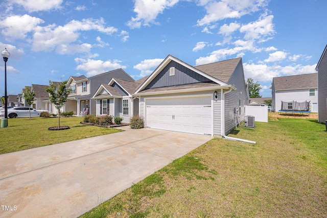 757 Frosty Way, Zebulon, NC 27597 - view of front of home with board and batten siding, driveway, a front yard, and a garage