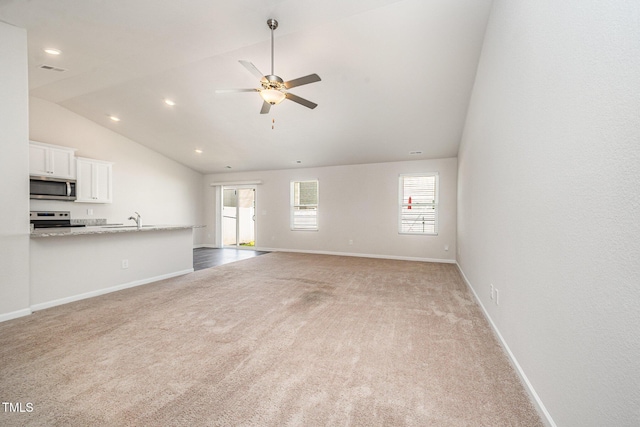 757 Frosty Way, Zebulon, NC 27597 - unfurnished living room featuring vaulted ceiling, light carpet, a ceiling fan, and recessed lighting