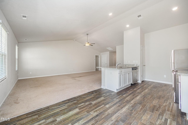 757 Frosty Way, Zebulon, NC 27597 - kitchen featuring ceiling fan, light stone counters, wood finished floors, stainless steel dishwasher, and vaulted ceiling