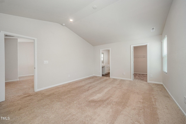 757 Frosty Way, Zebulon, NC 27597 - unfurnished bedroom with lofted ceiling, a spacious closet, and light carpet
