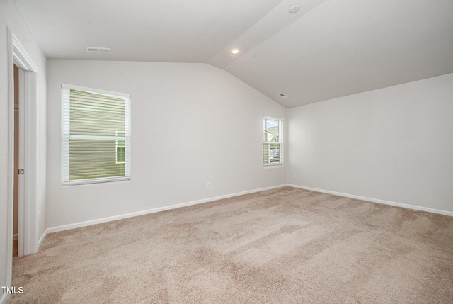 757 Frosty Way, Zebulon, NC 27597 - unfurnished bedroom with vaulted ceiling and light colored carpet