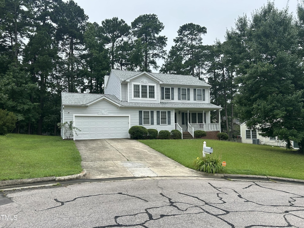 8 Colton Ct, Durham, NC 27713 - view of front of property with covered porch, concrete driveway, a front yard, and an attached garage