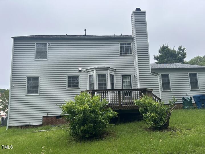 8 Colton Ct, Durham, NC 27713 - back of property with a chimney and a wooden deck