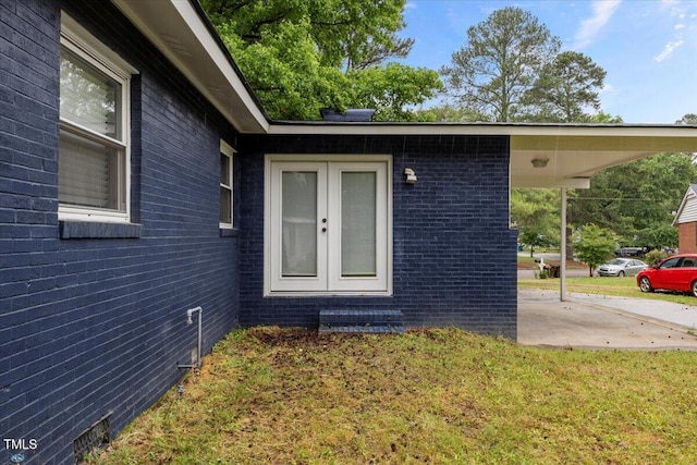 2752 Weldon Ter, Durham, NC 27703 - entrance to property with french doors, a lawn, and brick siding