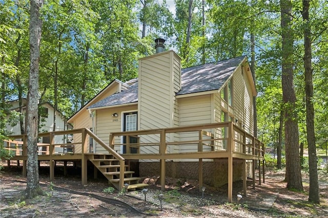 5905 Waters Edge Dr, Fayetteville, NC 28314 - back of property featuring a deck, a chimney, a shingled roof, and stairway