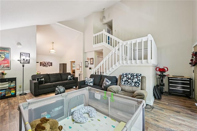 5905 Waters Edge Dr, Fayetteville, NC 28314 - living area featuring high vaulted ceiling, wood finished floors, and stairway