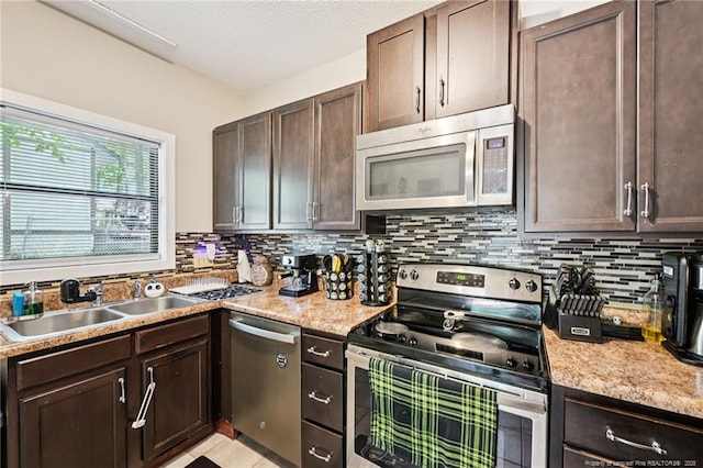 5905 Waters Edge Dr, Fayetteville, NC 28314 - kitchen with appliances with stainless steel finishes, dark brown cabinets, tasteful backsplash, and light countertops