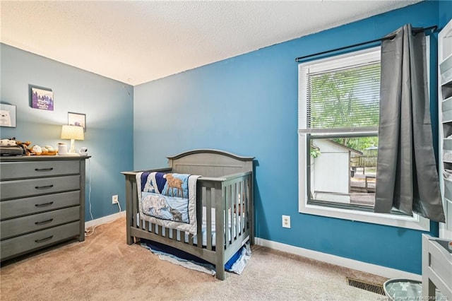 5905 Waters Edge Dr, Fayetteville, NC 28314 - carpeted bedroom with a nursery area and a textured ceiling