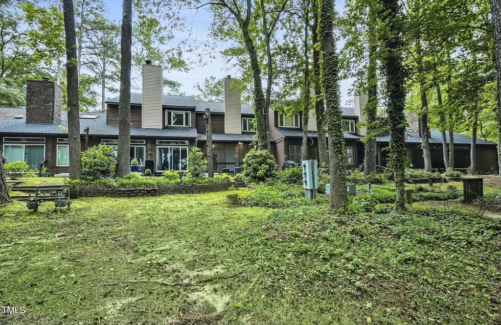 1311 Forest Hills Rd NW Unit E3, Wilson, NC 27896 - back of house featuring a chimney