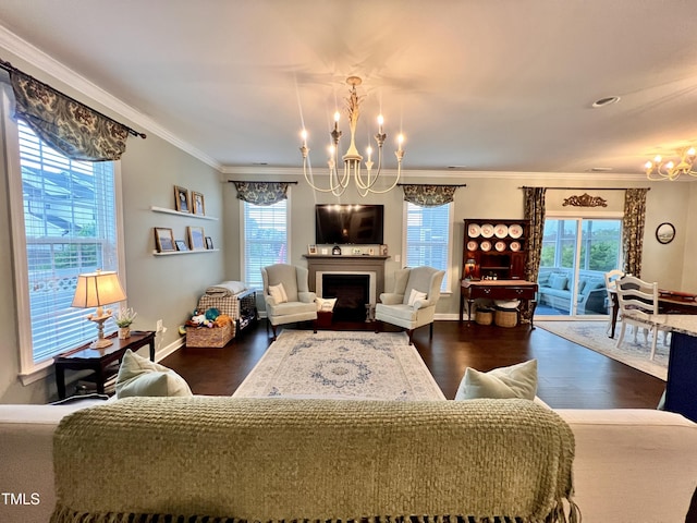 1925 Bright Kannon Way, Wendell, NC 27591 - living area with a chandelier, dark wood finished floors, crown molding, and a fireplace