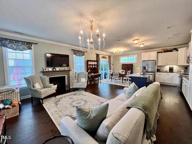 1925 Bright Kannon Way, Wendell, NC 27591 - living area with a chandelier, crown molding, dark wood-style floors, and a fireplace