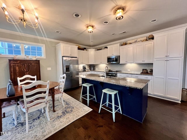 1925 Bright Kannon Way, Wendell, NC 27591 - kitchen with appliances with stainless steel finishes, light stone countertops, white cabinets, a breakfast bar, and a chandelier