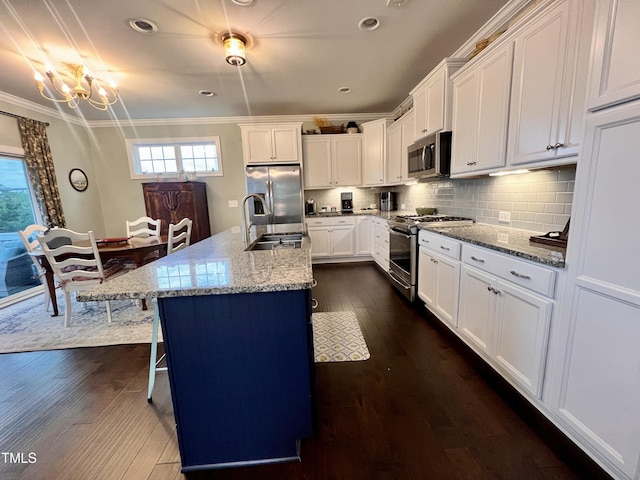 1925 Bright Kannon Way, Wendell, NC 27591 - kitchen with appliances with stainless steel finishes, dark wood-style flooring, ornamental molding, plenty of natural light, and a kitchen bar