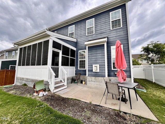 1925 Bright Kannon Way, Wendell, NC 27591 - rear view of house with a sunroom, a patio, entry steps, and a fenced backyard