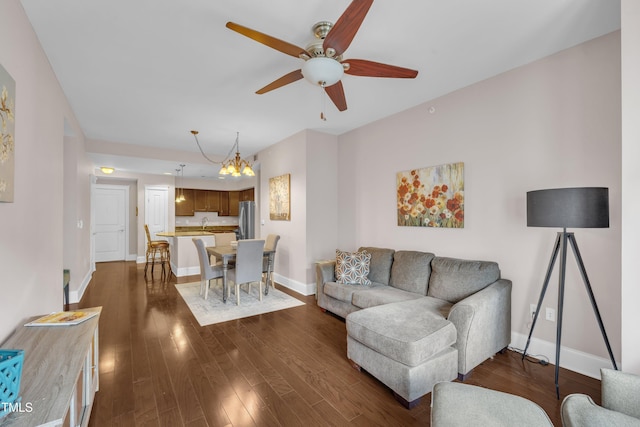 222 Glenwood Ave # 416, Raleigh, NC 27603 - living room with ceiling fan, a chandelier, and dark wood-style floors