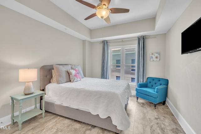 222 Glenwood Ave # 416, Raleigh, NC 27603 - bedroom featuring a ceiling fan and a tray ceiling