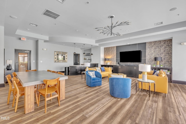 222 Glenwood Ave # 416, Raleigh, NC 27603 - living area with light wood-style floors, recessed lighting, and a chandelier