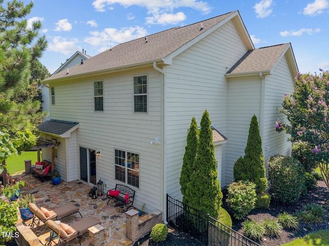 2505 Goldeneye Ct, Raleigh, NC 27606 - rear view of property featuring roof with shingles and a patio