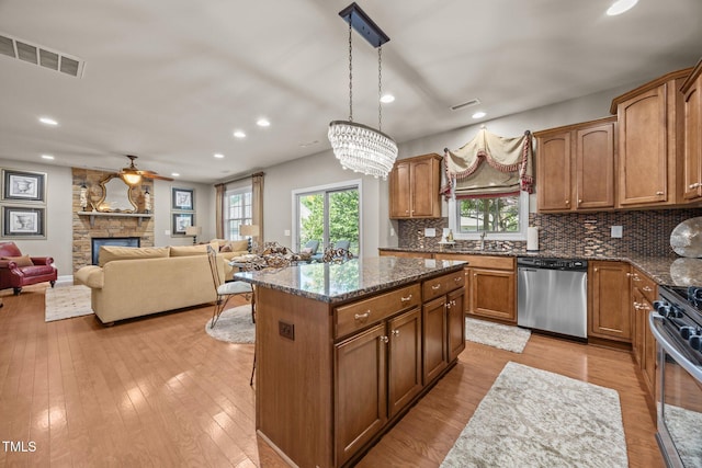 2505 Goldeneye Ct, Raleigh, NC 27606 - kitchen with healthy amount of natural light, appliances with stainless steel finishes, a center island, recessed lighting, and backsplash
