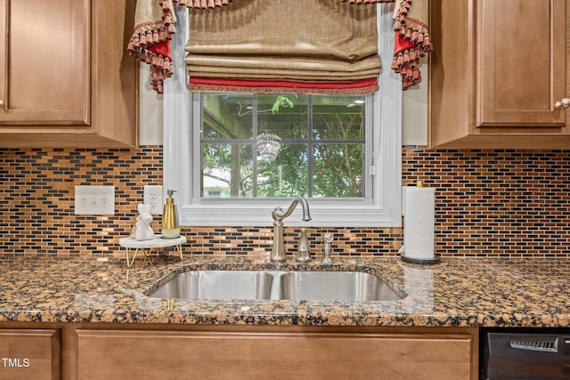 2505 Goldeneye Ct, Raleigh, NC 27606 - kitchen with tasteful backsplash, dishwashing machine, brown cabinets, and dark stone counters