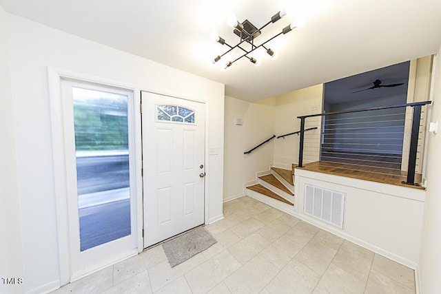 2309 Bertie Dr, Raleigh, NC 27610 - foyer featuring stairway, a chandelier, and light tile patterned flooring