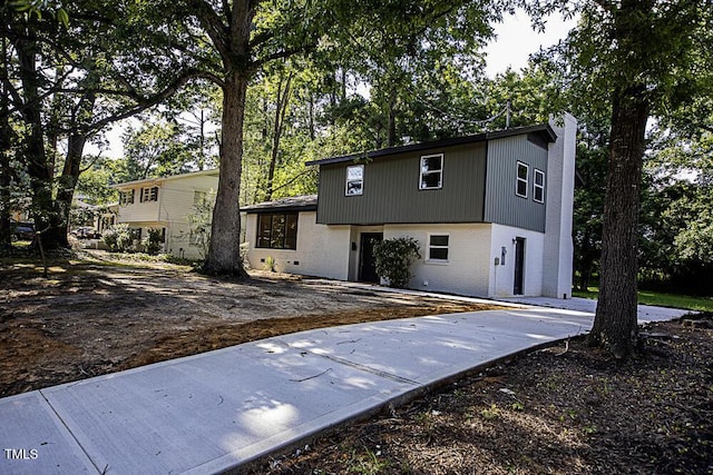 2309 Bertie Dr, Raleigh, NC 27610 - tri-level home with brick siding and a chimney